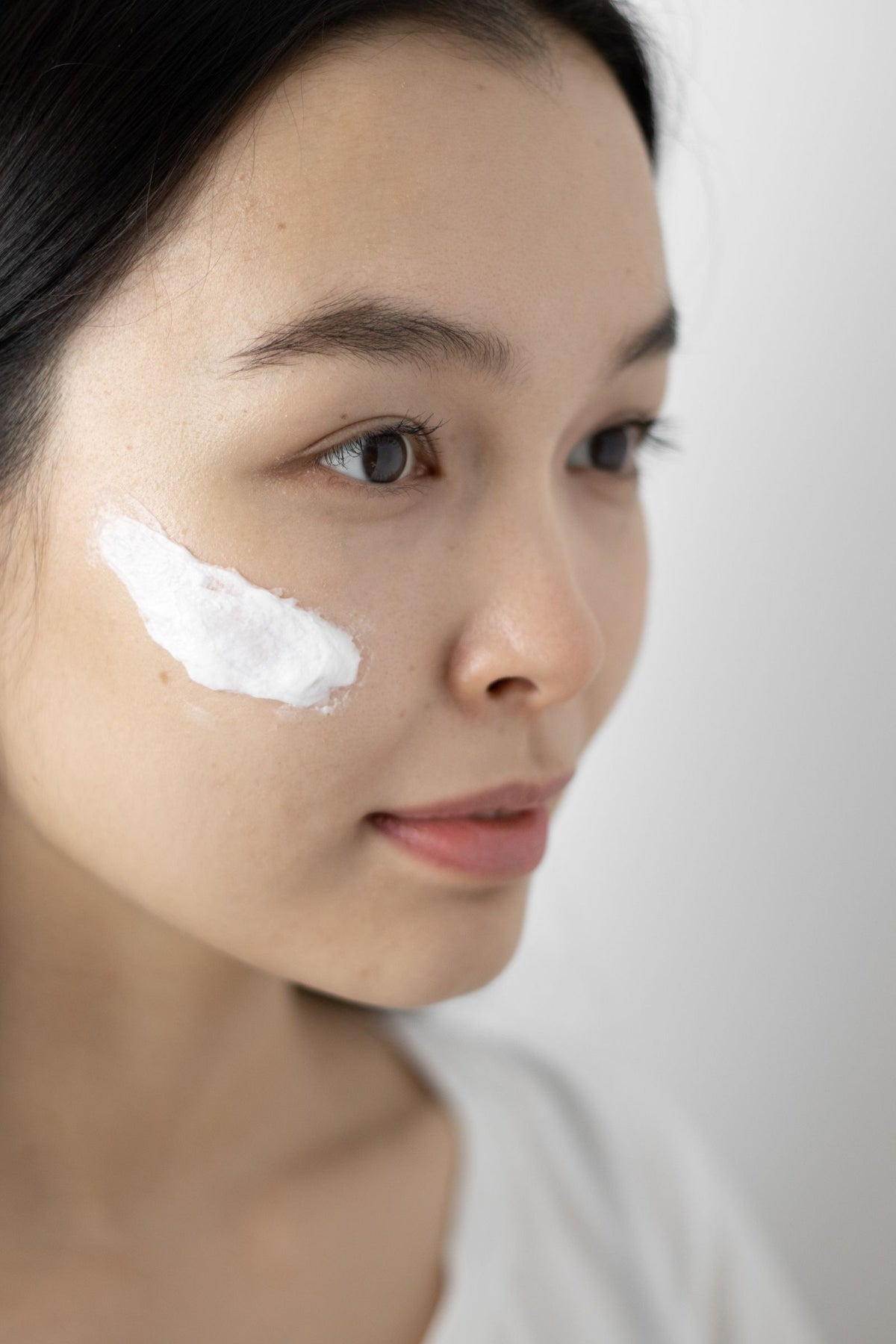 Woman with skincare product on her face
