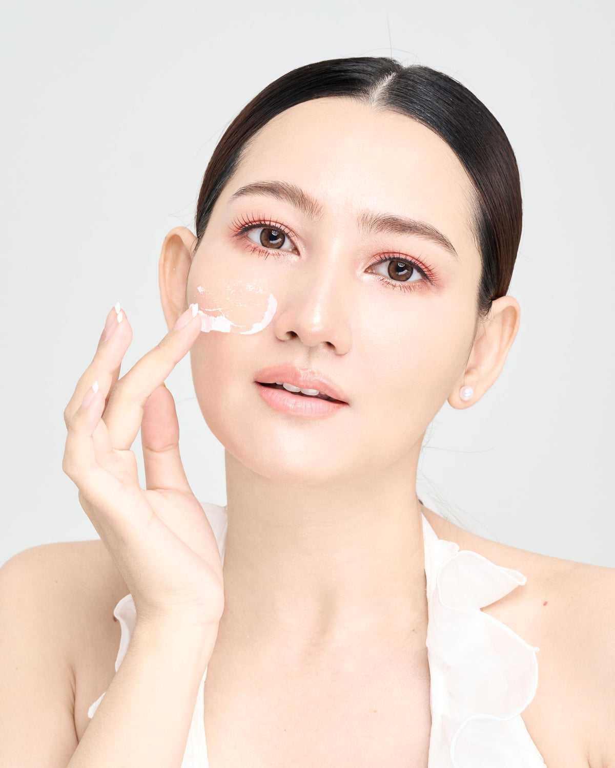 Woman applying skincare for glowing skin